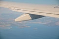 The sea and the island looked out of the plane window with wing aircraft .Beautiful blue sea and landscape view from the Royalty Free Stock Photo