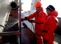 The Sea of Japan / Russia - December 01 2013: Cleaning the net of epibenthic sledge with the water hose