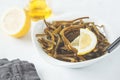 Sea kale kelp salad with oil and lemon in a white plate, white b Royalty Free Stock Photo