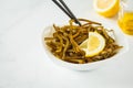 Sea kale kelp salad with oil and lemon in a white plate, white b Royalty Free Stock Photo