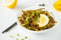 Sea kale kelp salad with oil and lemon in a white plate, white b Royalty Free Stock Photo