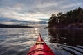 Sea Kayak paddling in the Pacific Ocean. Dramatic Sunset Sky. Royalty Free Stock Photo