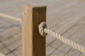 Wooden post. Rope. Knot. Tree structure. Sea knot on a sesal rope. Royalty Free Stock Photo