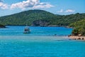 Sea lagoon with turquoise water, cruise touristic boat, rocks and cliffs Royalty Free Stock Photo