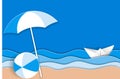 Sea landscape with paper ship in ocean waves, beach umbrella and bright ball on the sandy beach Royalty Free Stock Photo