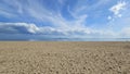 Sea landscape with sandy beach and beautiful sky with white clouds Royalty Free Stock Photo
