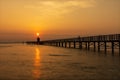 Sea landscape. Sunrise at the old red lighthouse of Lignano with a shelter, wooden quay. Royalty Free Stock Photo