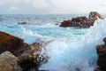 Sea landscape, wave and rocks. Stormy waves crashing into rocks. Royalty Free Stock Photo