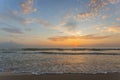 The sea is lapping the sand beach in evening sunset. Blue orange sky with sea view background Royalty Free Stock Photo