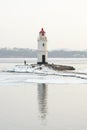 Sea lighthouse at winter cloudy day. Royalty Free Stock Photo