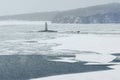 Sea lighthouse at winter cloudy day. Royalty Free Stock Photo