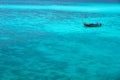The sea looks out to emerald blue. There is 1 floating boat quietly on the waves in the Andaman Sea Royalty Free Stock Photo
