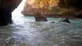 Ocean marble cave in the fire of the sun`s glare during sunset. The splashes of water on the cave wall.