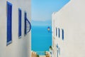 Sea and mountain views between two houses with blue windows, Sidi Bou Said, Tunisia Royalty Free Stock Photo