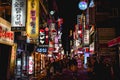 People walking in the sea of neon advertisement boards in Myeongdong Seoul South Korea