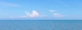 Sea or ocean calm water with blue sky and white clouds. Royalty Free Stock Photo