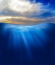 Sea or ocean underwater with sunset sky Royalty Free Stock Photo