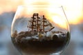 Sea old ship in a bottle and a glass wine glass Royalty Free Stock Photo