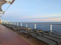 At sea 2025.09.13. - Open deck with empty sunbeds during sunset onboard a cruise ship Royalty Free Stock Photo