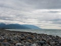Sea and a pebble beach on a cloudy summer or autumn day Royalty Free Stock Photo
