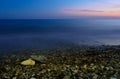 Sea and the pebble beach at sunset Royalty Free Stock Photo
