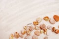 Sea pebbles on fine light sand. Sand texture. Sandy beach Royalty Free Stock Photo