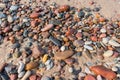 Sea pebbles on the sand, small smooth stones, stony seashore