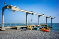 Sea pier with crane lifts water bike Royalty Free Stock Photo