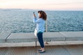 The sea pier a woman shoots photos