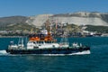 Sea Pilot `Adis` is sailing in blue water Black Sea. White work boat `Adis` on Novorossiysk Commercial Sea Port and mountains