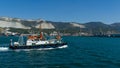 Sea Pilot `Adis` is sailing in blue water Black Sea. White work boat `Adis` on Novorossiysk Commercial Sea Port and mountains