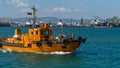 Sea Pilot `Lotsman-1` is sailing in turquoise water along Tsemes bay. Close-up of orange boat `Pilot-1` on Novorossiysk