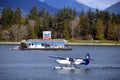 Sea plane and Chevron marine fuel barge in Vancouver, Canada