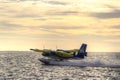 Sea plane taking off at sunset Royalty Free Stock Photo