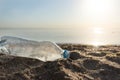 Wasted Plastic Bottle Lying On Beach Near Water, Ecological Background Royalty Free Stock Photo