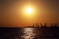 Sea port of Berdyansk on sunset background