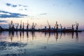 Sea port cranes, sunset, Odessa, Ukraine Royalty Free Stock Photo