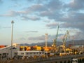 Sea port. Sunset at the port. Cargo part of the sea station. industrial area against the backdrop of mountains. Fuel wagons