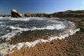 Sea remote bay with rocks and stones. Sea surf on the beach in an abandoned bay Royalty Free Stock Photo