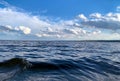 Sea ripples. Bright background. Dark blue water. Shallow waves and sun glare on the water. Abstract Royalty Free Stock Photo