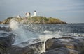 sea rock landscape with wave crushing. Nubble Lighthouse, historic lighthouse, Cape Neddick Point, York, Maine, USA.