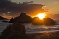 Sea rocks with dramatic clouds at sunset , Kastani Mamma Mia beach, island of Skopelos