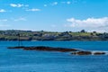 Sea rocks in the middle of blue water on a hot summer day. Clear sky over the Atlantic Ocean coast. Blue sea under blue sky Royalty Free Stock Photo