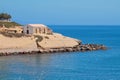 Sea, rocky cape with church. Porto-Torres, Italy Royalty Free Stock Photo