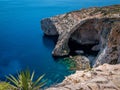 Sea rocky cave complex Blaue Grotte with the crystal clear blue water in the background Malta