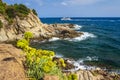 Sea and rocky coastline in Lloret de Mar on sunny summer day. Spanish seascape in Costa Brava