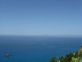 Sea with rocky island and Stromboli Royalty Free Stock Photo