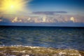 Sea rolling and receding water in rays of setting sun. Royalty Free Stock Photo