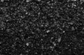 Sea salt background or texture in black color. Little minerals Royalty Free Stock Photo