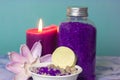 Sea salt for bath in a bottle, burning candle, lotus flower. Soap or dry shampoo